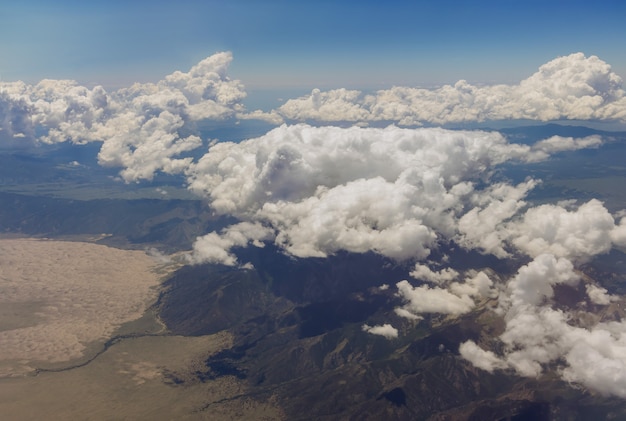 Scenic landscape of mountain Arizona with clear fluffy clouds the mountain range from on the airplane in USA