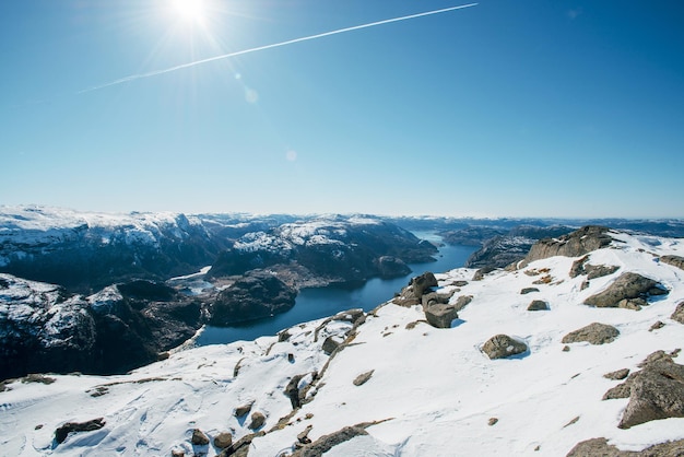 Scenic landscape of river channel sea between rocky shore with snow View of the Pulpit Rock Preikestolen Norwegian mountains Lysefjord Norway