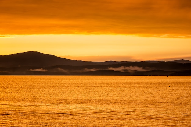 Scenic orange yellow sunset on the lake