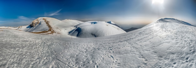 scenic panoramic winter landscape with snow covered mountains in Italy