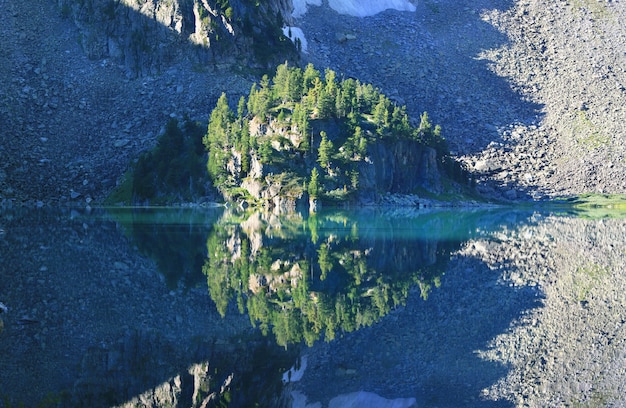 Scenic reflection in a mountain lake on a summer morning