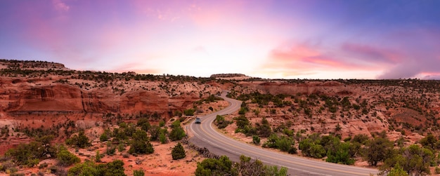 Scenic road surrounded by red rock mountains in the desert