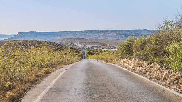 Scenic road with views of the mountains at sunset