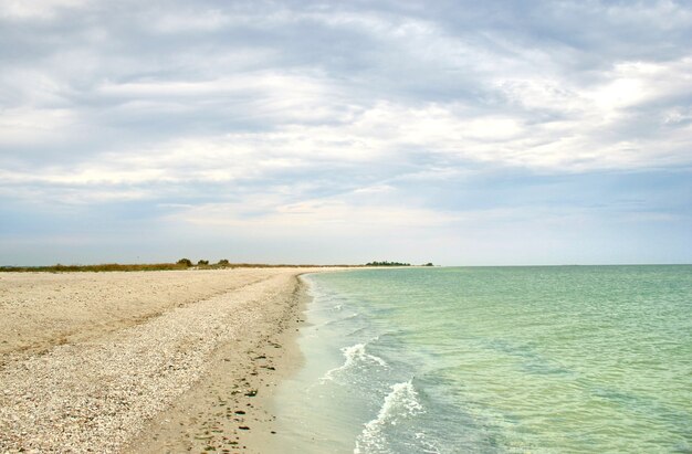 Scenic seascape with waves and empty beach.