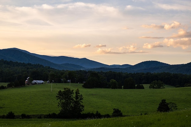 Scenic shot of grass fields and mountain silhouettes in Madison County Virginia USA during dusk