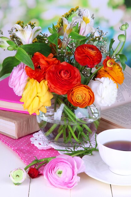 Scenic still life of flowers buttercups on wooden table on natural background