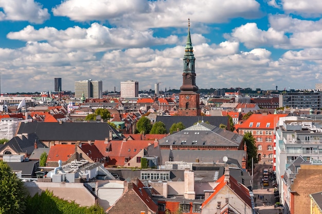 Scenic summer aerial view of Old Town skyline with St. Peter's Church and lot of red roofs as seen from The Round Tower, Copenhagen, capital of Denmark