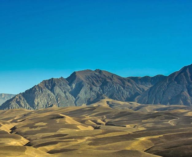 Photo scenic view of arid landscape against clear blue sky