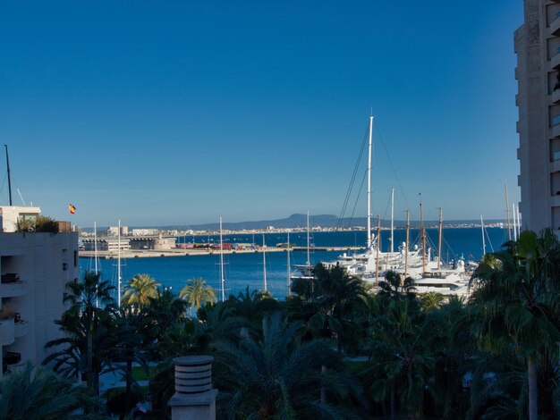 Scenic view of bay against clear blue sky