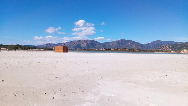 Scenic view of beach against blue sky