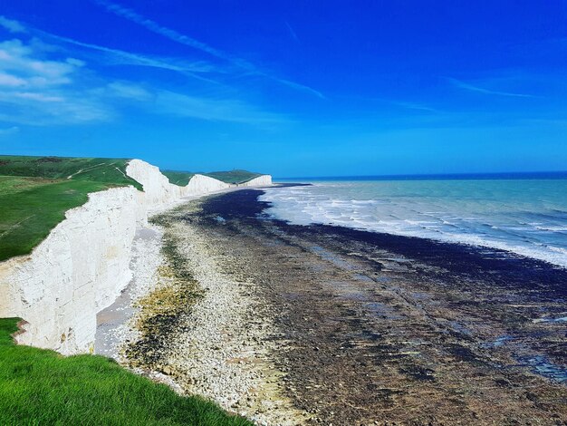 Scenic view of beach against blue sky