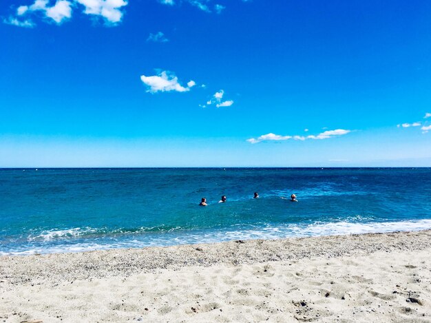 Scenic view of beach against blue sky