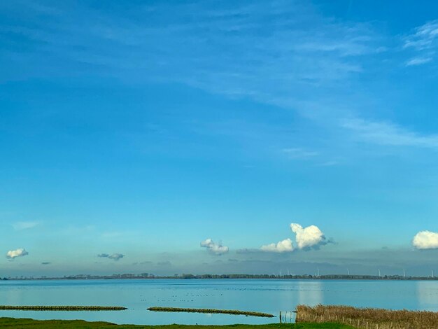 Scenic view of beach against blue sky