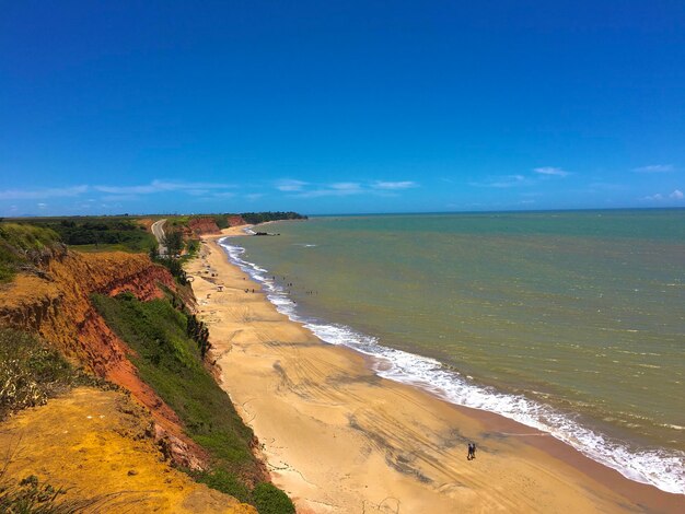 Scenic view of beach against blue sky