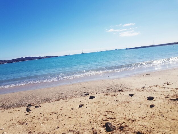 Scenic view of beach against blue sky