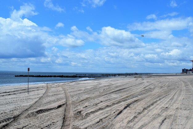 Scenic view of beach against blue sky