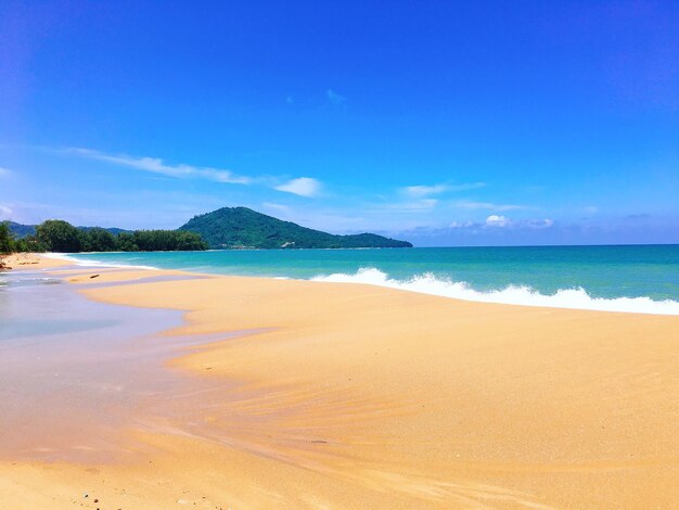 Scenic view of beach against blue sky