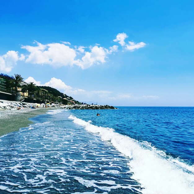 Scenic view of beach against blue sky