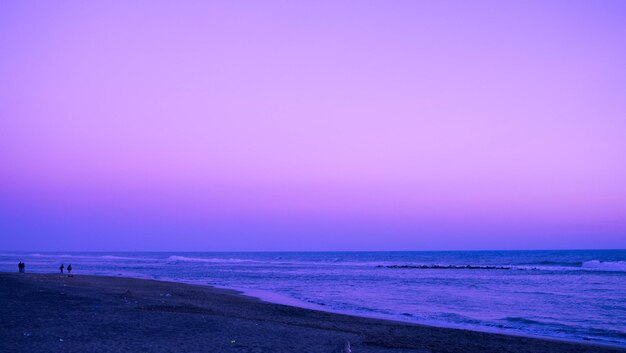 Scenic view of beach against blue sky