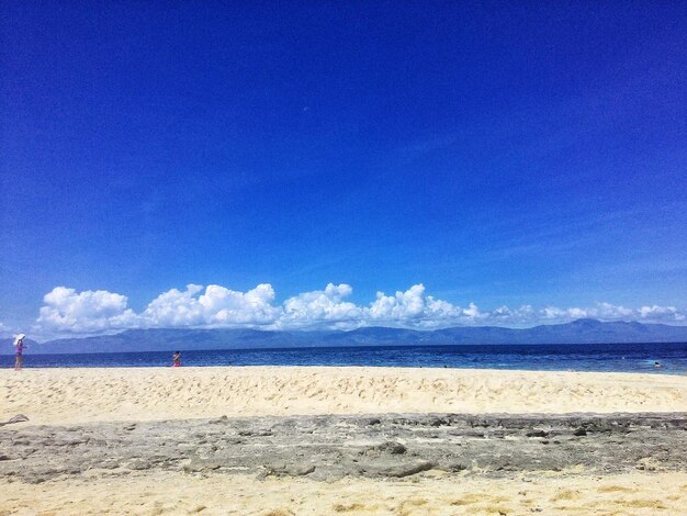 Scenic view of beach against blue sky