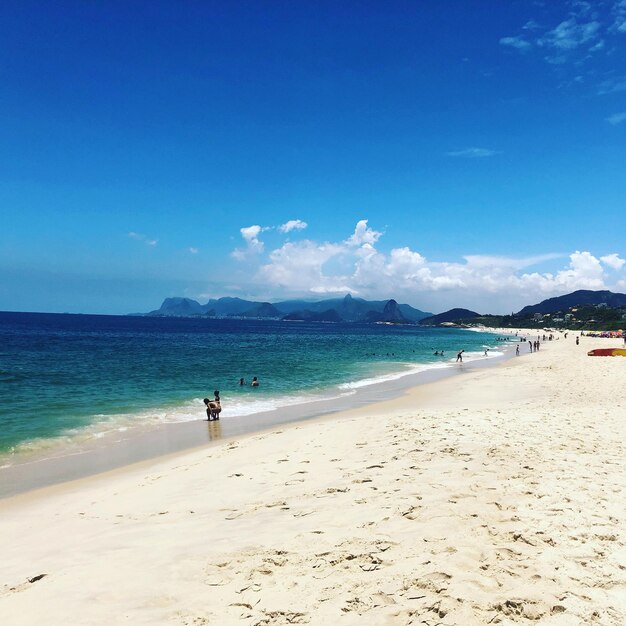 Scenic view of beach against blue sky