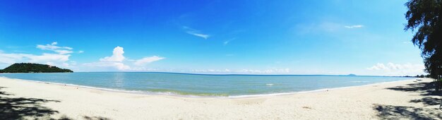 Scenic view of beach against blue sky