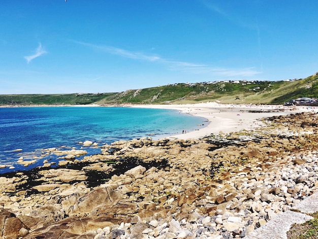 Scenic view of beach against blue sky