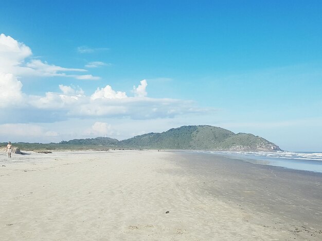 Scenic view of beach against blue sky