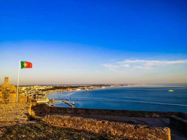 Scenic view of beach against blue sky