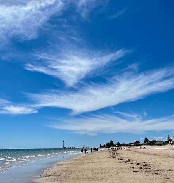 Scenic view of beach against blue sky