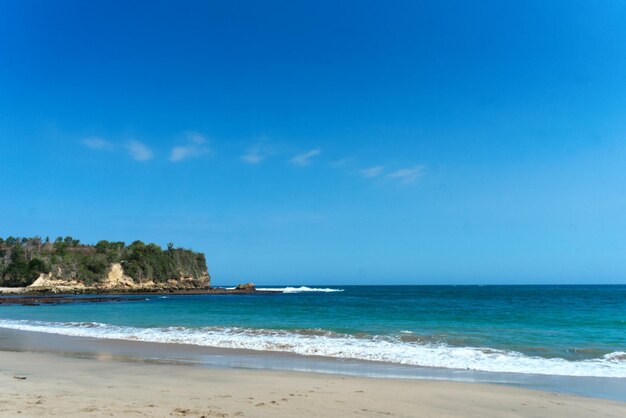 Scenic view of beach against blue sky