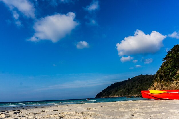 Scenic view of beach against blue sky