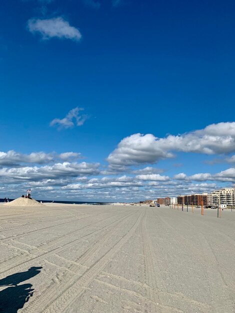 Scenic view of beach against blue sky