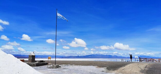 Scenic view of beach against blue sky