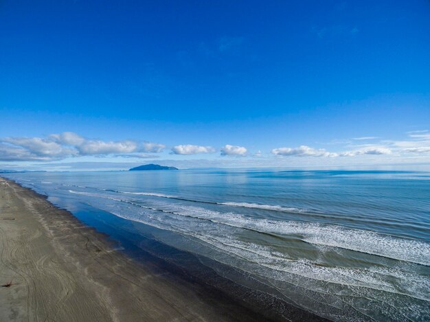 Scenic view of beach against blue sky