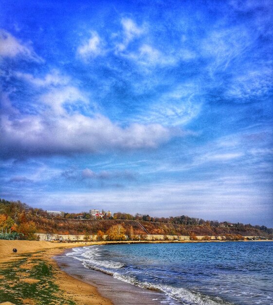 Scenic view of beach against blue sky