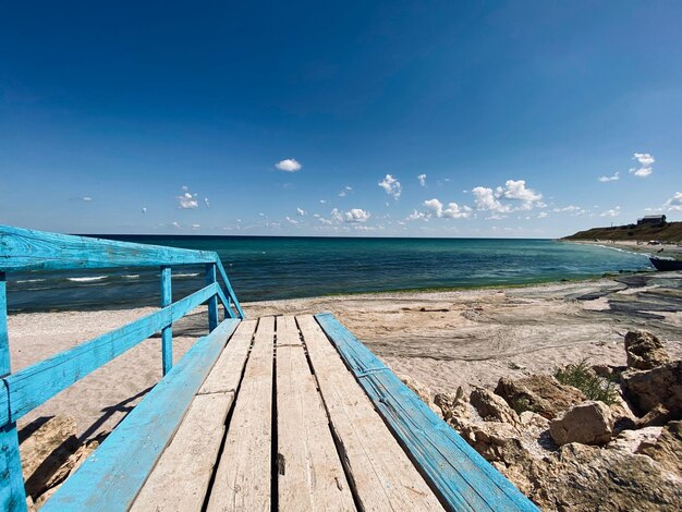 Scenic view of beach against blue sky