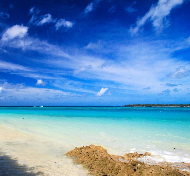 Scenic view of beach against blue sky