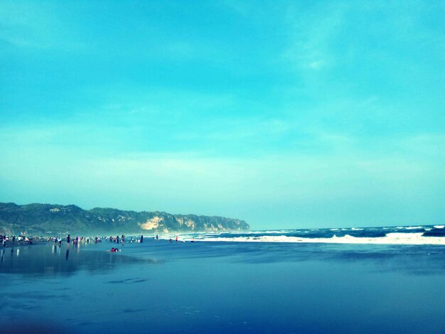 Scenic view of beach against blue sky