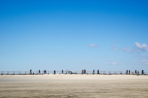 Scenic view of beach against blue sky