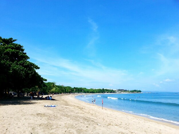 Scenic view of beach against blue sky