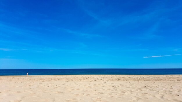 Scenic view of beach against blue sky