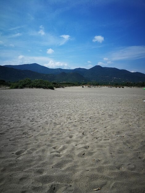 Scenic view of beach against blue sky