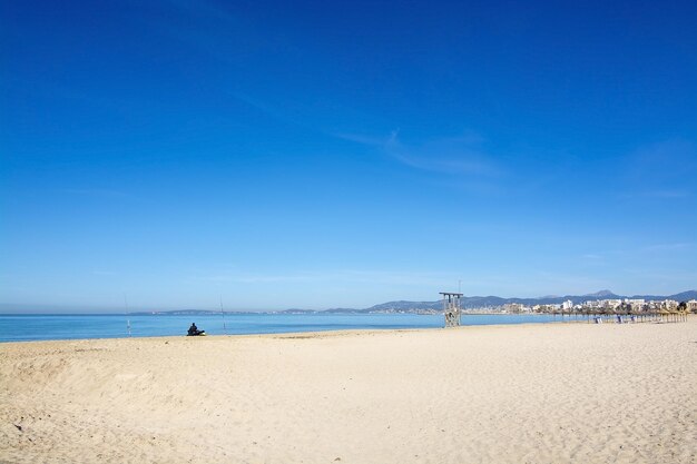 Scenic view of beach against blue sky