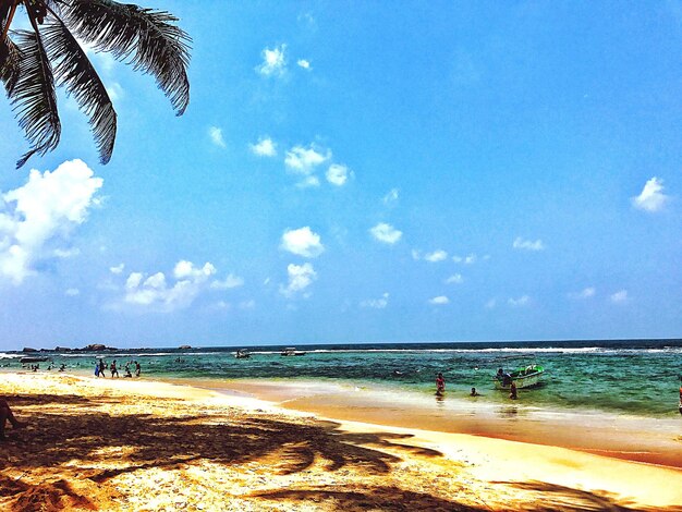 Scenic view of beach against blue sky