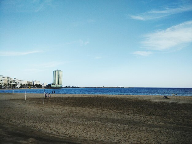 Scenic view of beach against clear blue sky