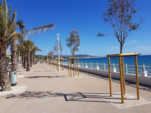 Scenic view of beach against clear blue sky