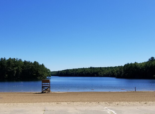 Scenic view of beach against clear blue sky