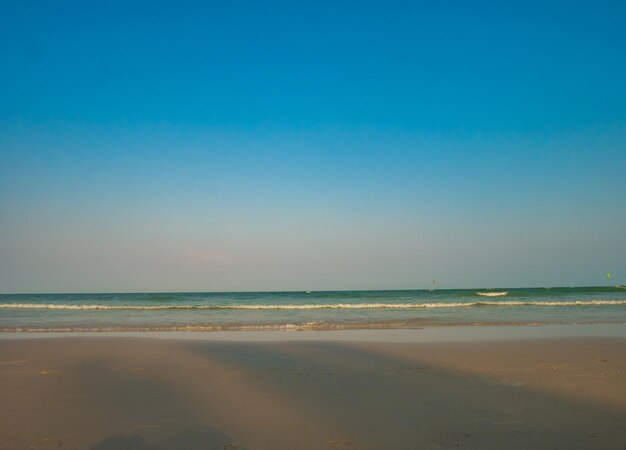 Scenic view of beach against clear blue sky