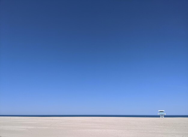 Photo scenic view of beach against clear blue sky